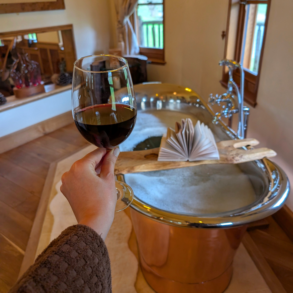 Vivianna's copper bath tub with wooden board across for drinks